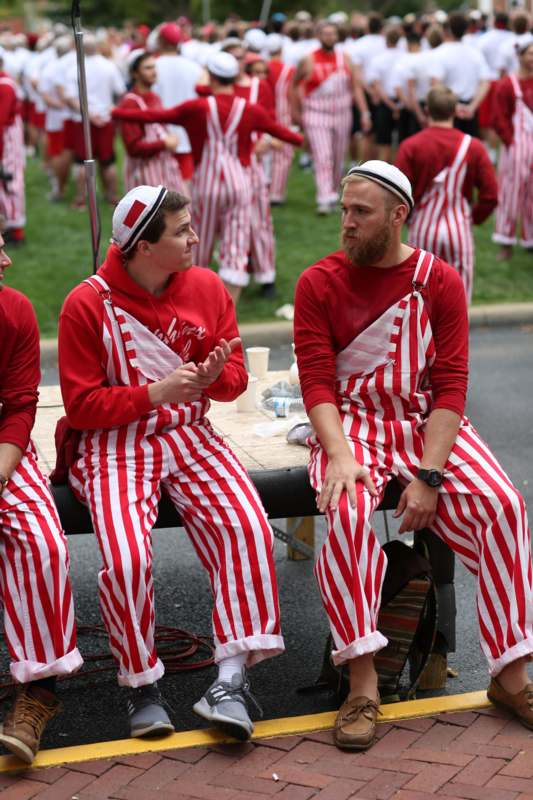 a group of men wearing red and white striped outfits