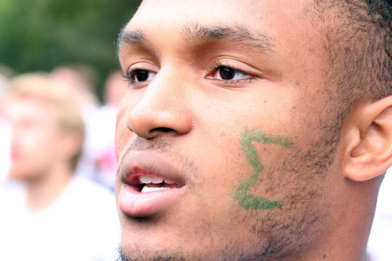 a man with a green mark on his face