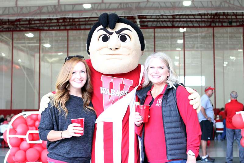 a group of women posing with a mascot