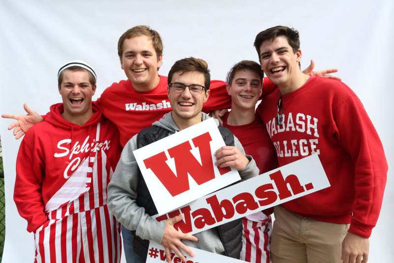 a group of men wearing red and white shirts