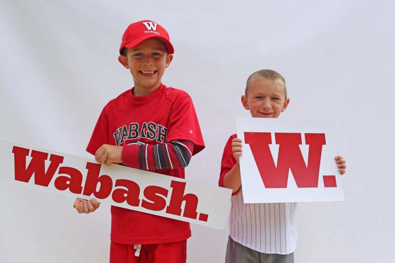 two boys holding signs with letters