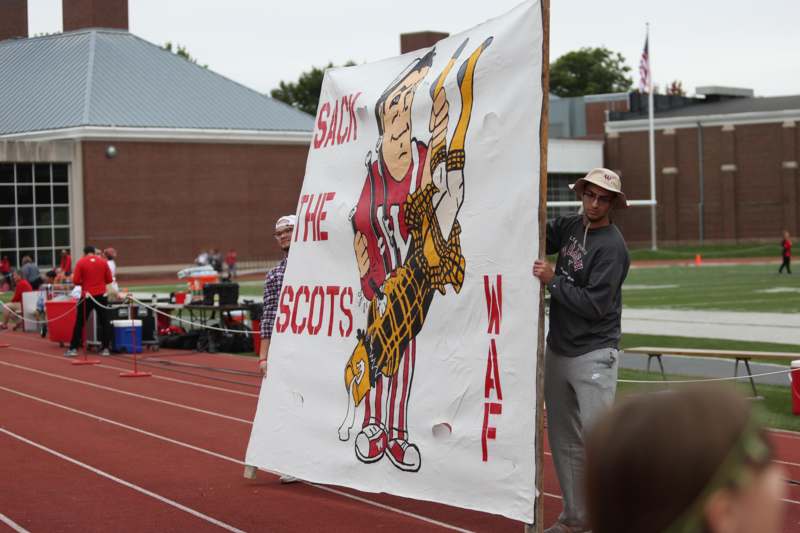 a man holding a large sign