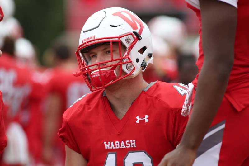 a football player wearing a red and white helmet