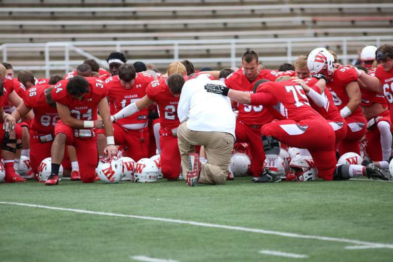 a football players kneeling on the ground