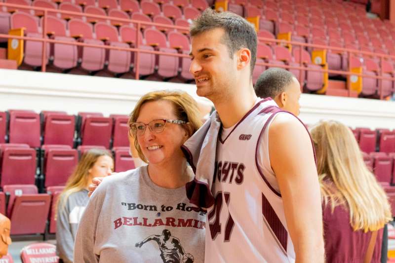 a man and woman in a basketball uniform