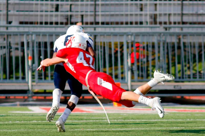 a football player falling into another football player