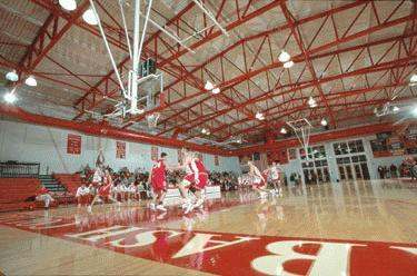a group of people playing basketball