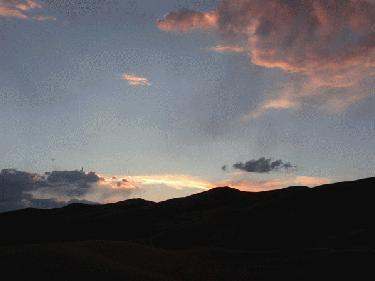 a sunset over a mountain