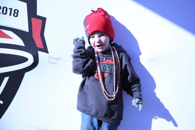 a child wearing a red hat and a red beanie