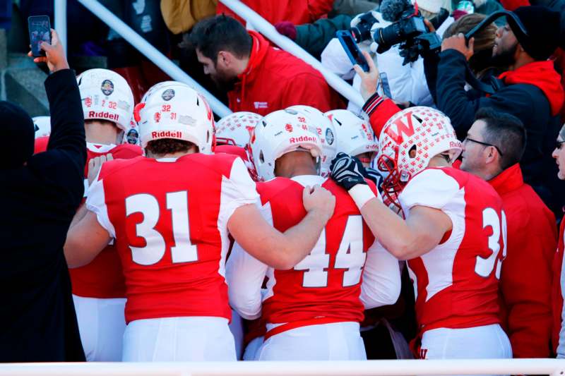 a group of football players in a huddle