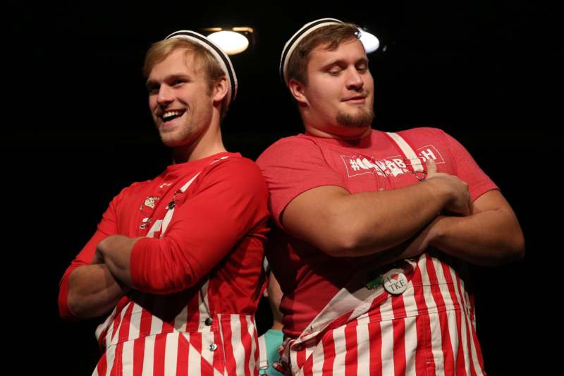 two men wearing red and white striped overalls
