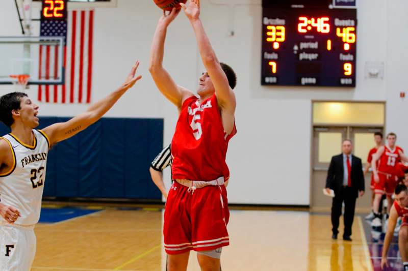a man in a red uniform playing basketball