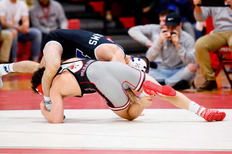 a man wrestling on the floor