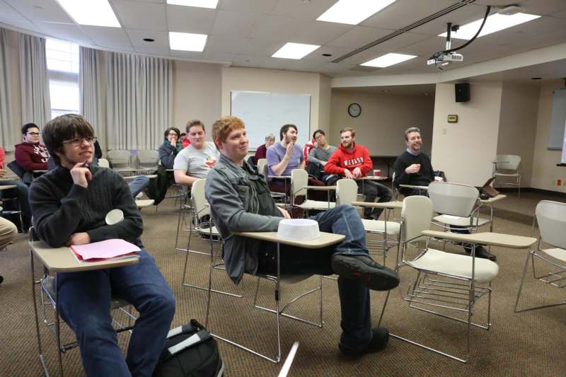 a group of people sitting in a classroom