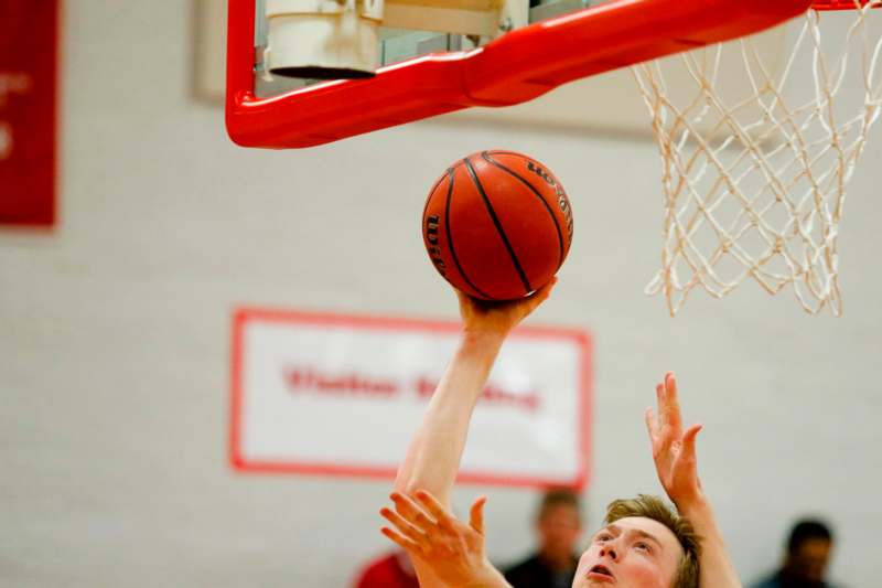 a man reaching for a basketball