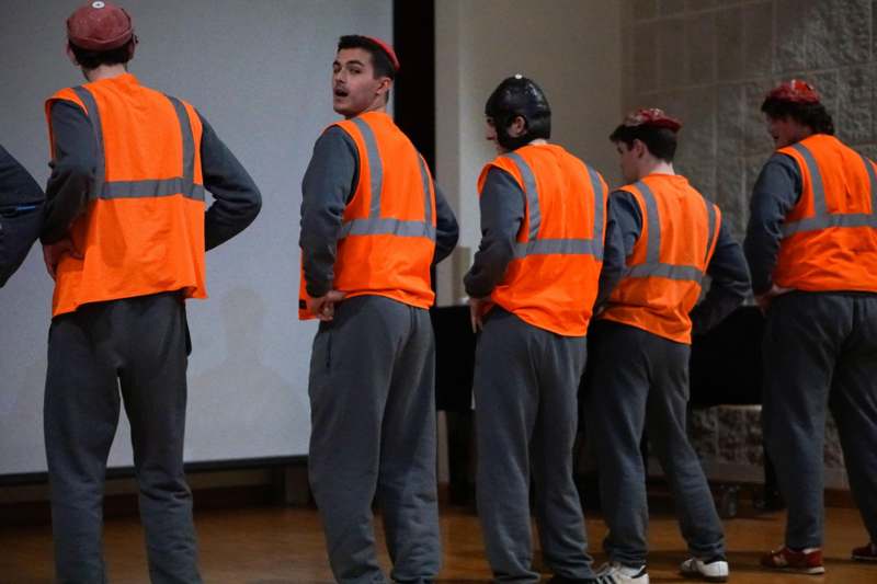 a group of men in orange vests