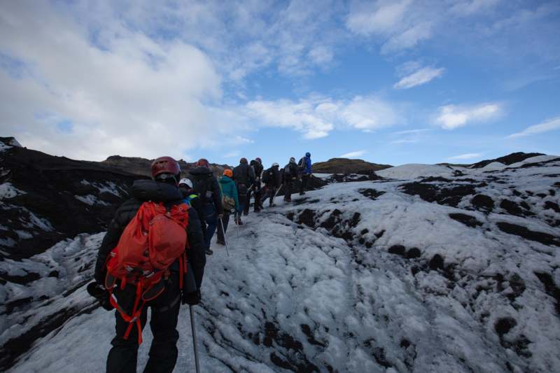 a group of people walking on a snowy mountain