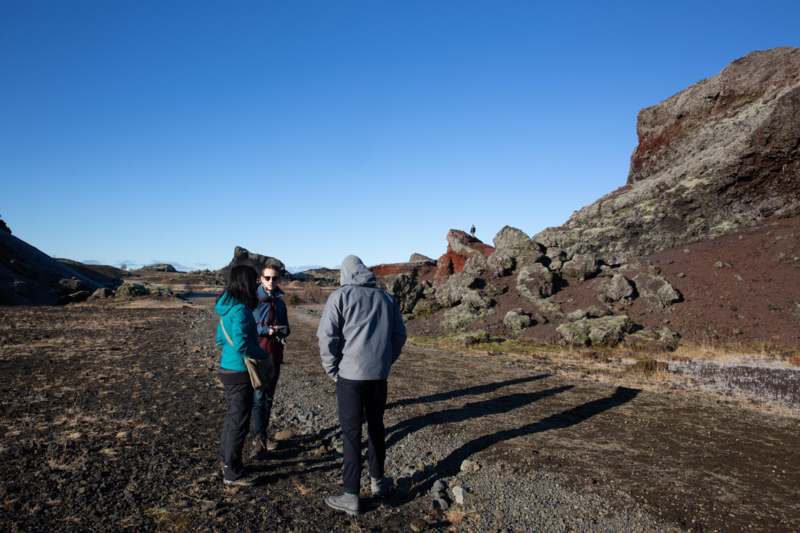 a group of people standing in a rocky area