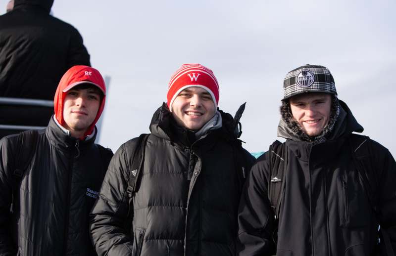 a group of men wearing winter hats