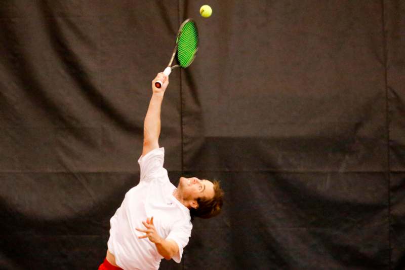 a man swinging a tennis racket