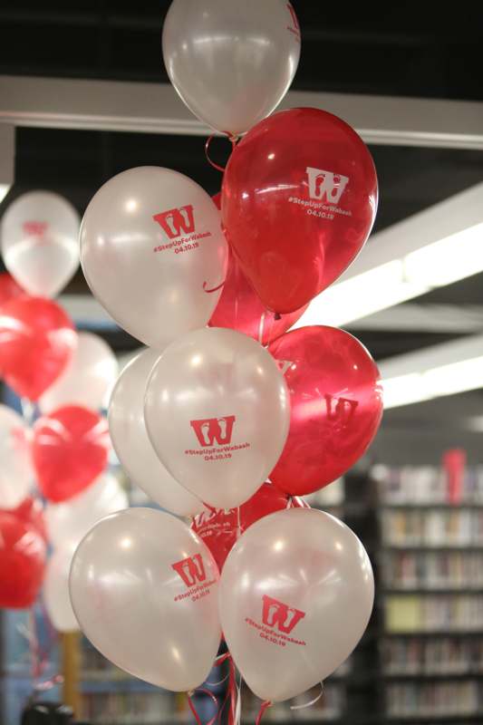 a bunch of balloons in a library