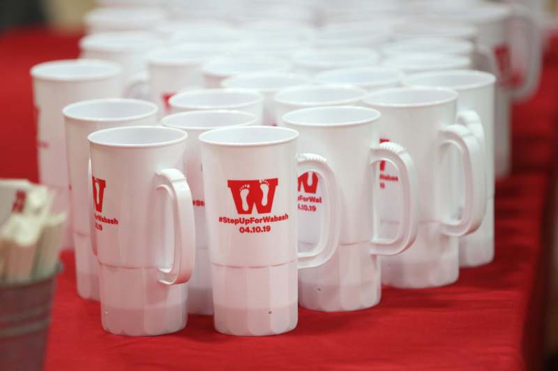 a group of white mugs with red text on them