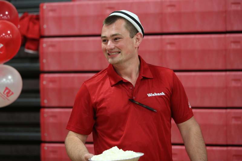 a man holding a bowl of whipped cream