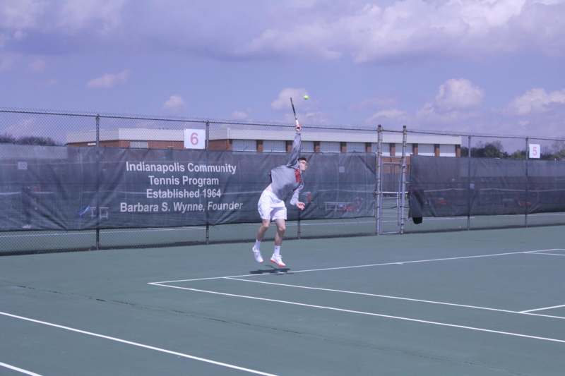 a man swinging a tennis racket