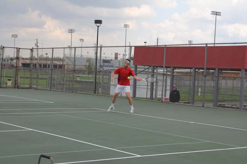 a man playing tennis on a court