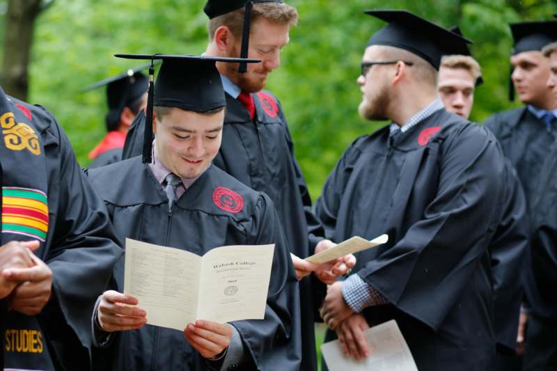a group of people in graduation gowns and cap and gowns