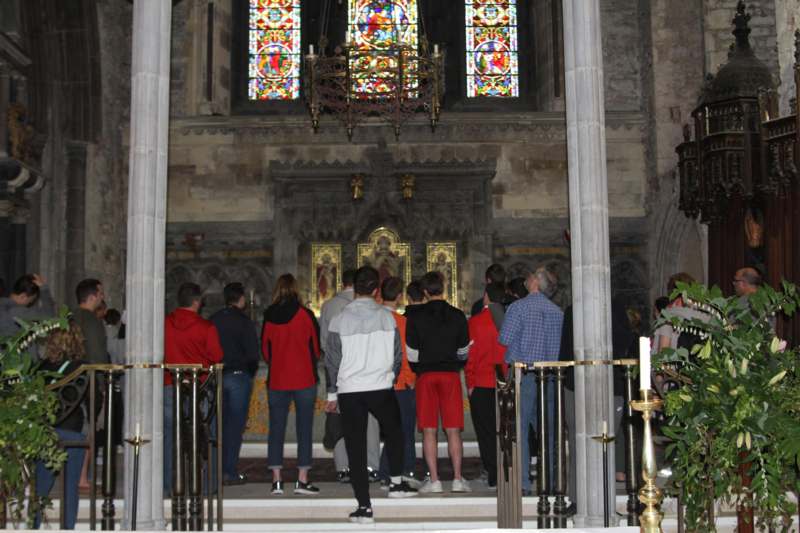 a group of people standing in a church