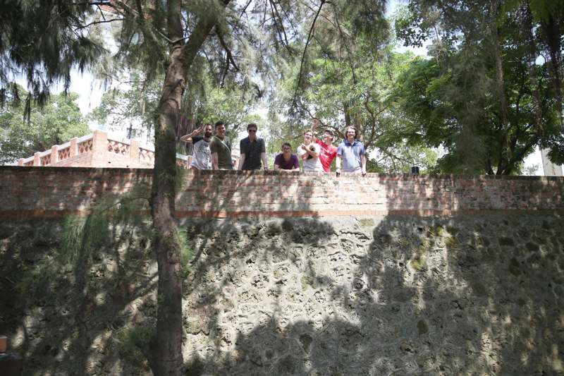 a group of people standing on a wall