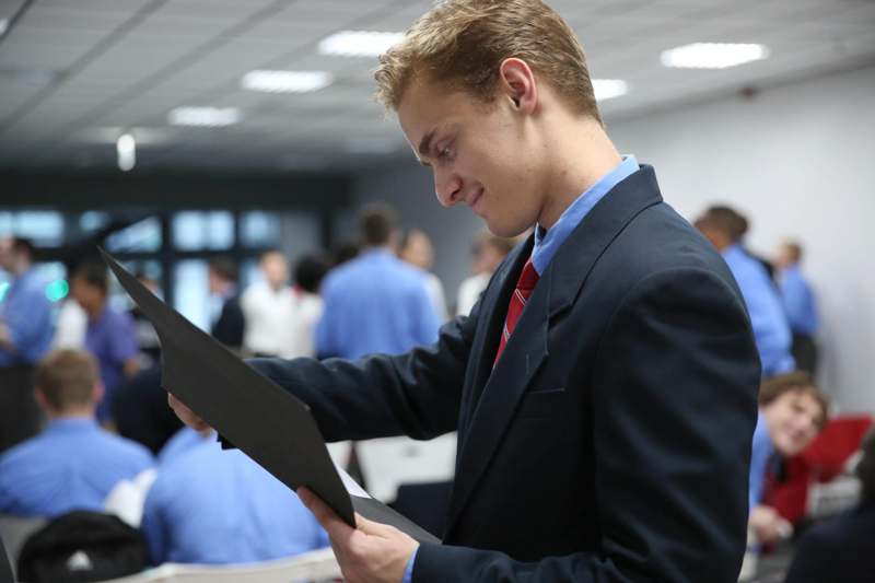 a man in a suit looking at a piece of paper