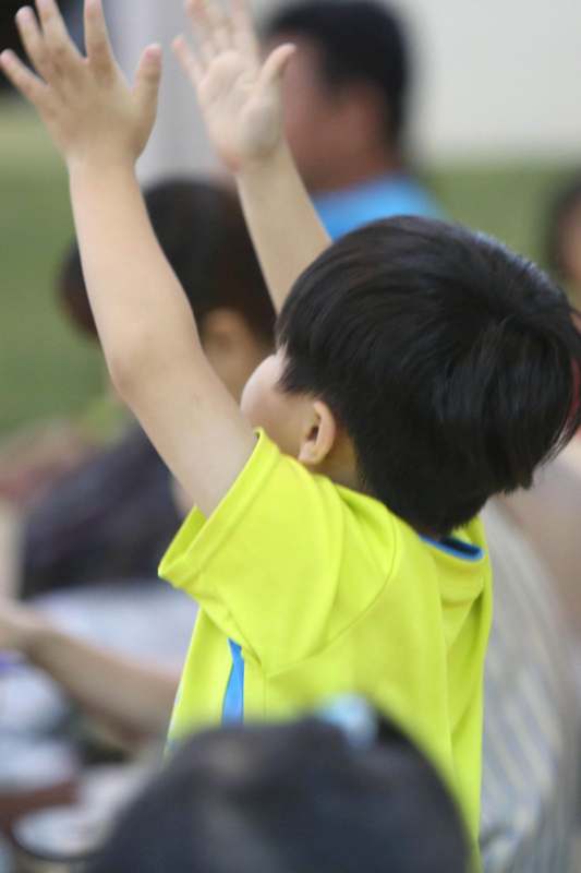 a child raising his hands