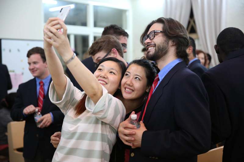 a group of people taking a selfie