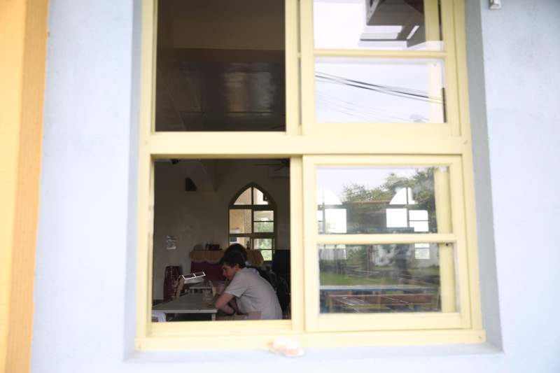 a window with a person sitting at a table