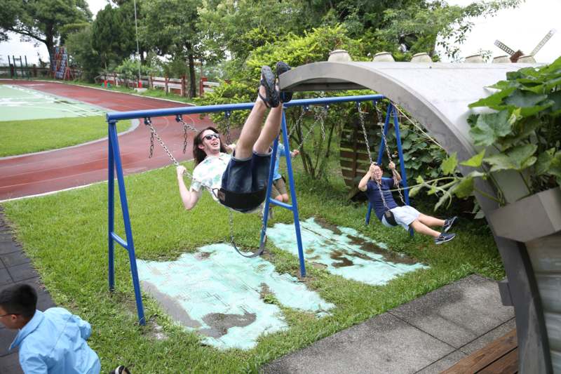 a woman and child on a swing set