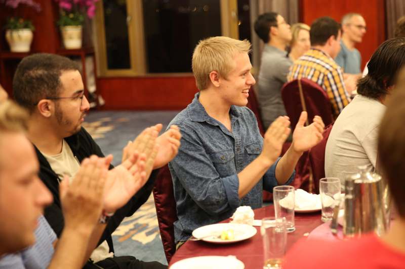 a group of people clapping at a table