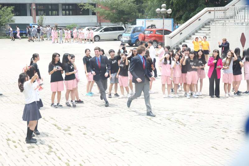 a group of people in pink uniforms