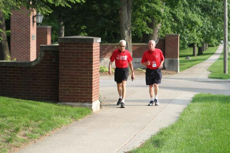 two men running on a sidewalk