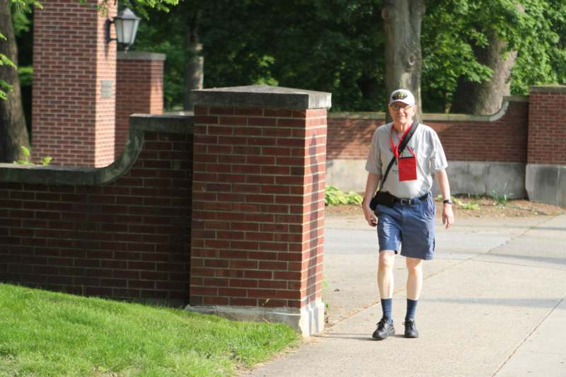 a man walking on a sidewalk