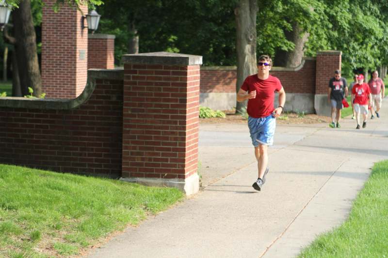 a man running on a sidewalk