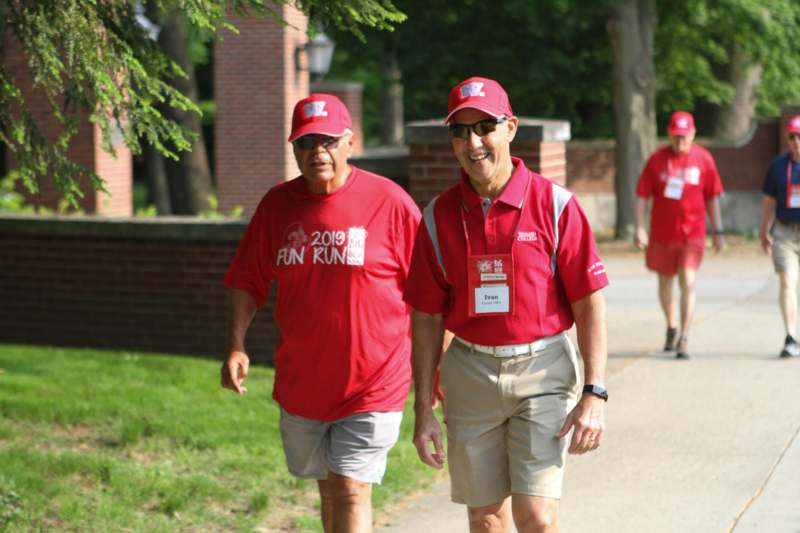 a group of men wearing matching red shirts and hats