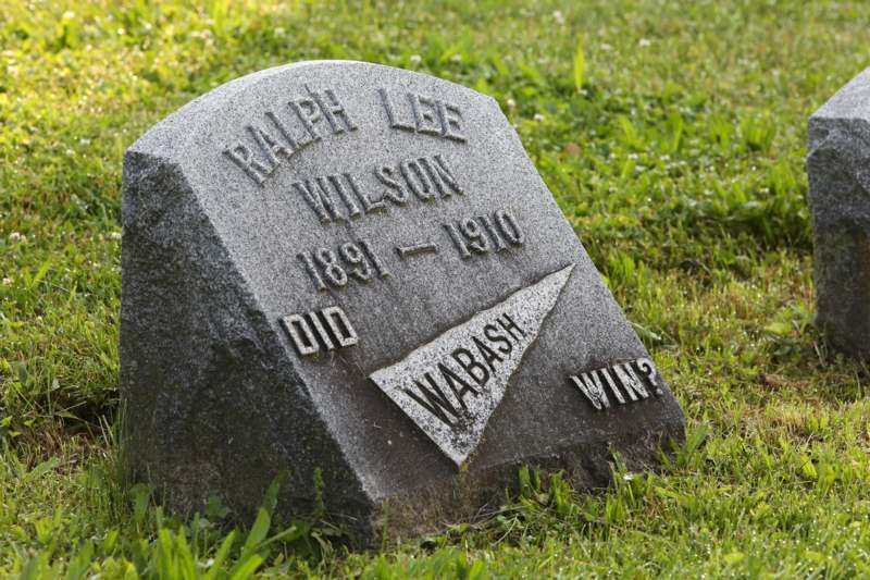 a tombstone in the grass