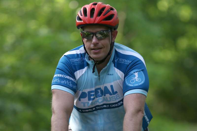 a man wearing a helmet and cycling outfit