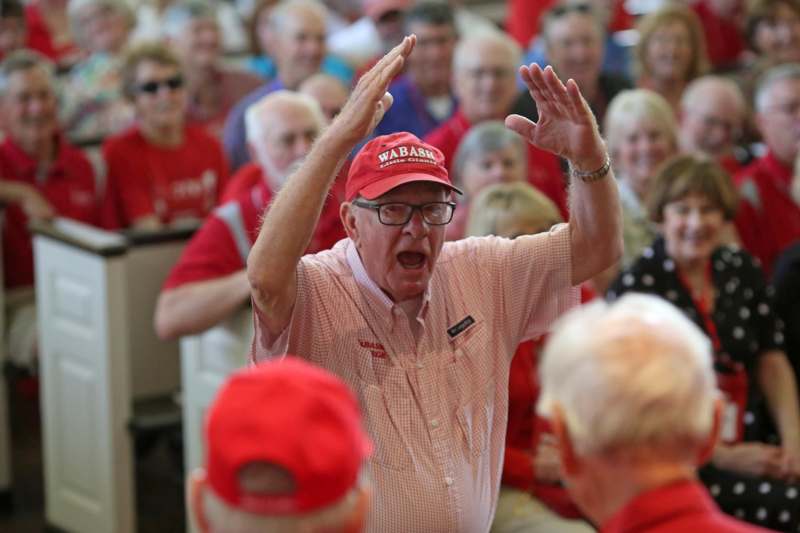 a man in a red hat with his hands up