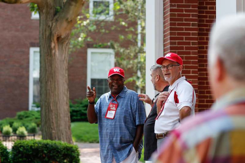 a group of men wearing red hats