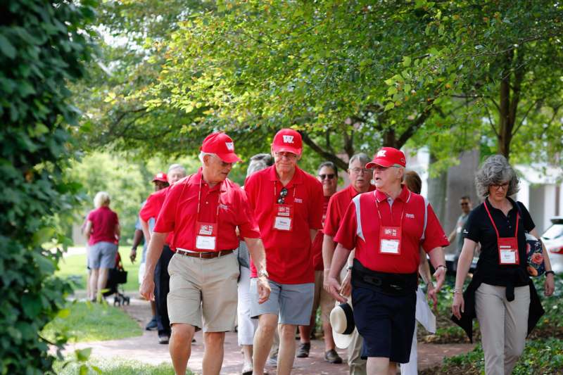 a group of people wearing red shirts and matching hats