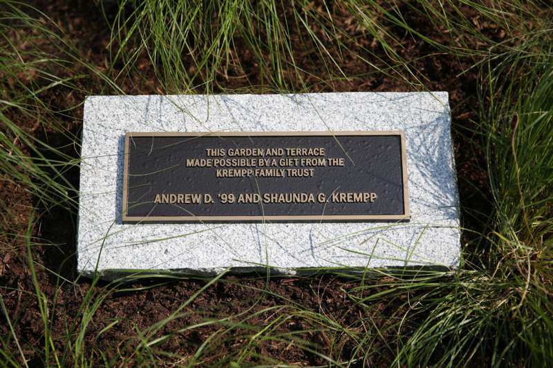 a plaque on a stone in the grass