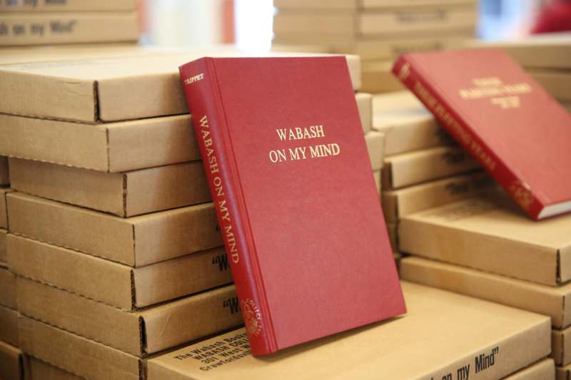 a red book on top of a stack of cardboard boxes
